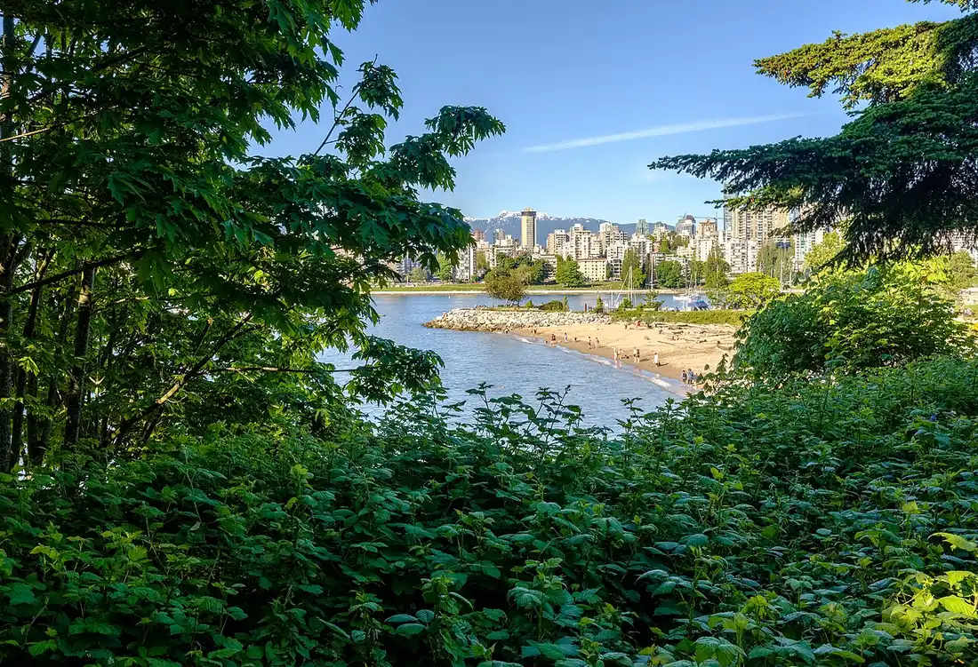 Kitsilano Beach in the foreground with the downtown Vancouver skyline across English Bay