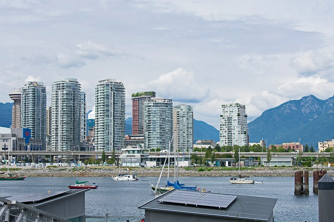 The glass towers of Yaletown reflected in the water of False Creek