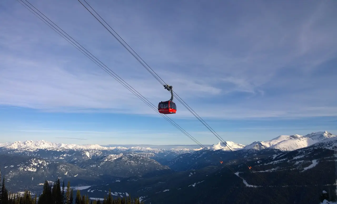 A Peak 2 Peak gondola cabin crossing high above the valley between Whistler and Blackcomb at dawn