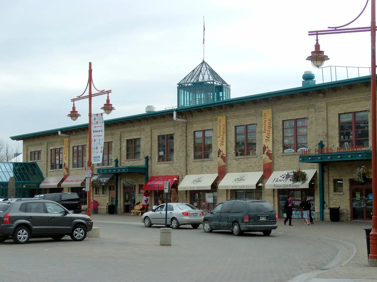 The brick towers and glass canopy of The Forks Market building in Winnipeg on a clear day