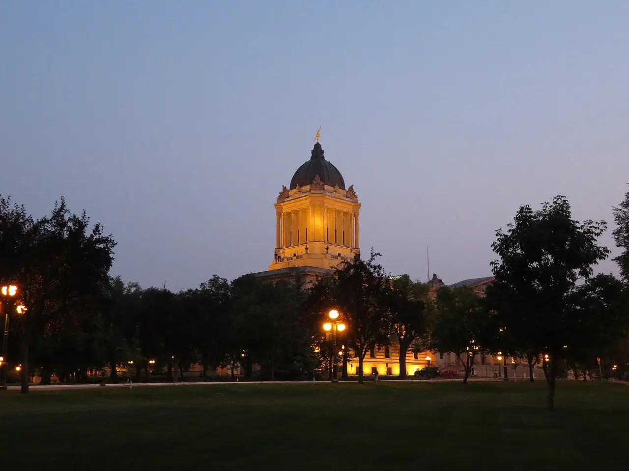 The neoclassical Manitoba Legislative Building in Winnipeg seen across its lawns in summer